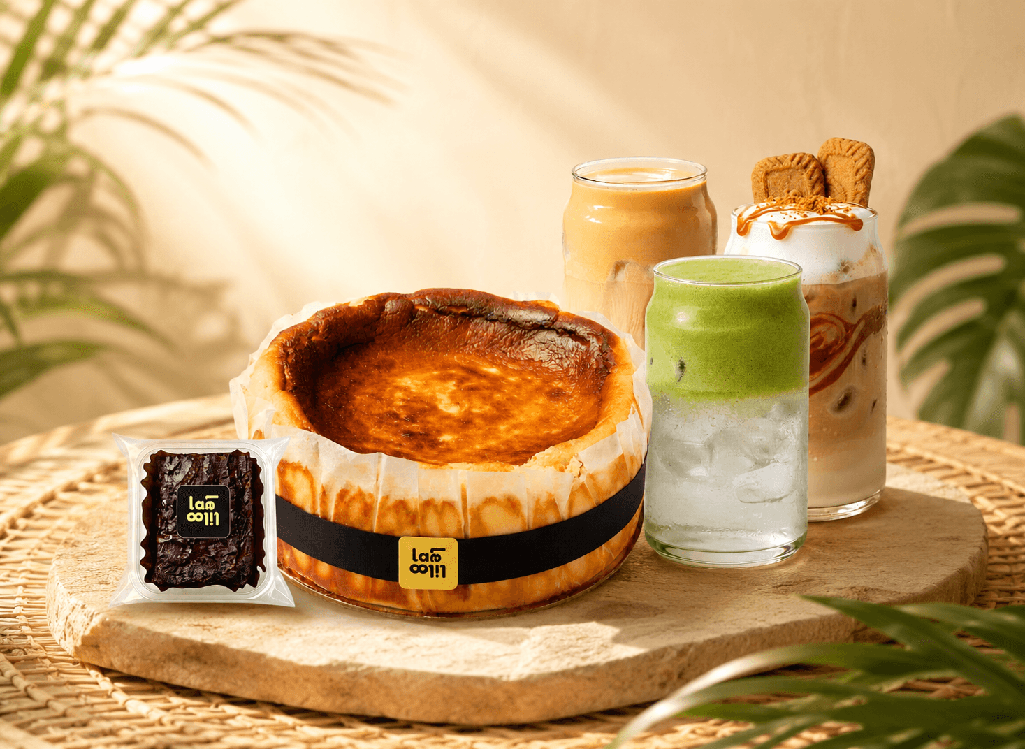 A selection of laleliloo drinks and treats — burnt basque cheesecake, brownie, matcha latte, and iced coffees